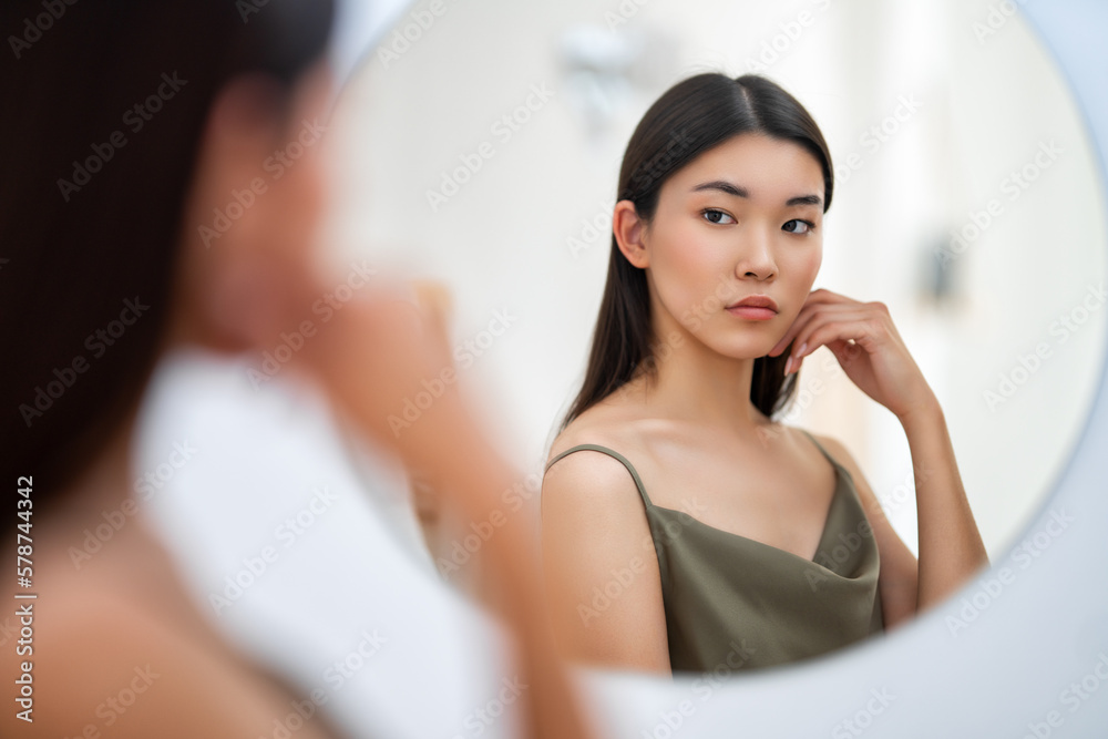 woman looking at mirror