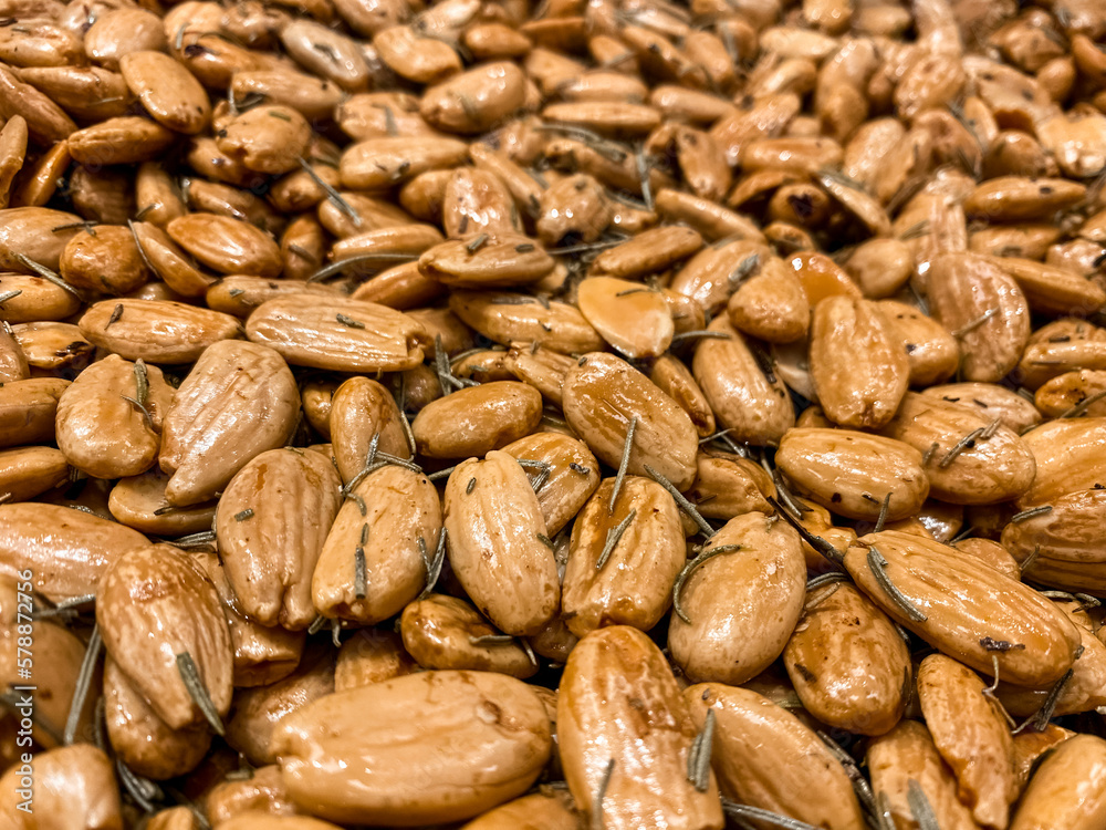 Roasted almond nuts as background, closeup