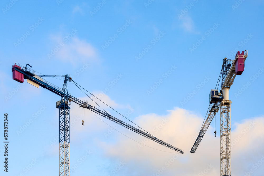 View of construction cranes on sunny day