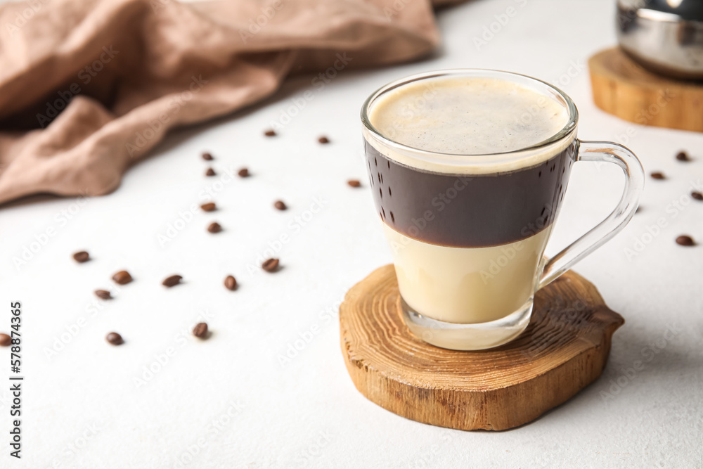 Glass cup of delicious Cafe Bombon on light table