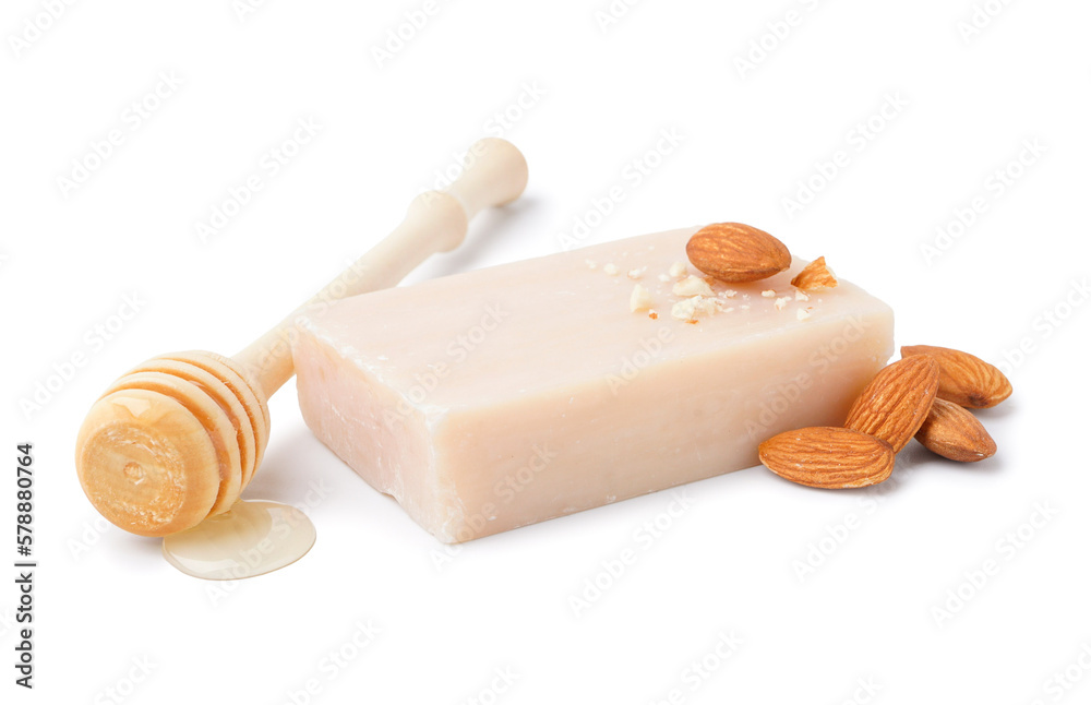 Soap bar, almond nuts and honey on white background