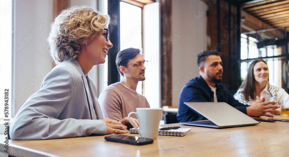 Business discussion in a conference meeting, business people sit together on a table in an office