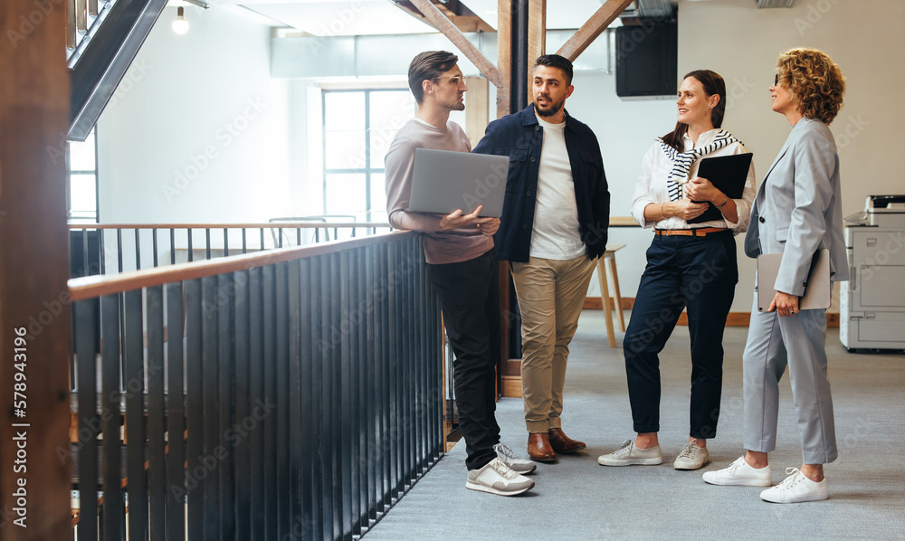 Tech professionals having a standup meeting in an office