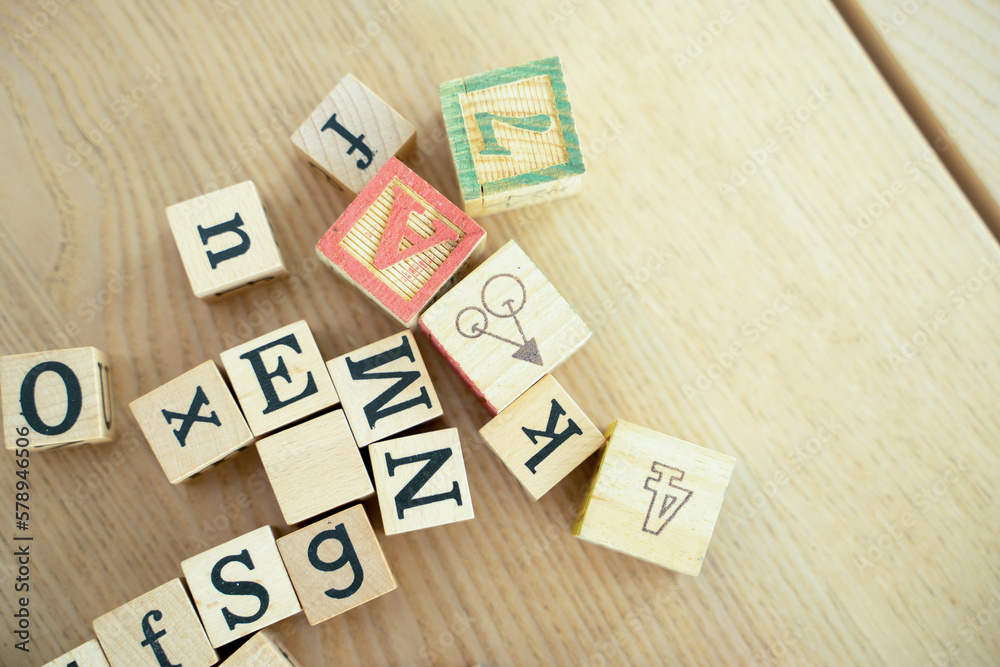 Toys children and learning,Wooden cubes with numbers and colorful toy bricks on a wooden background.