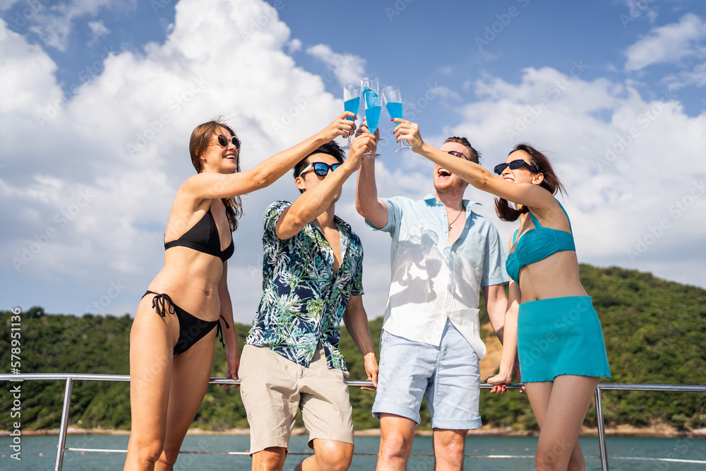 Group of diverse friends drink champagne while having a party in yacht. 