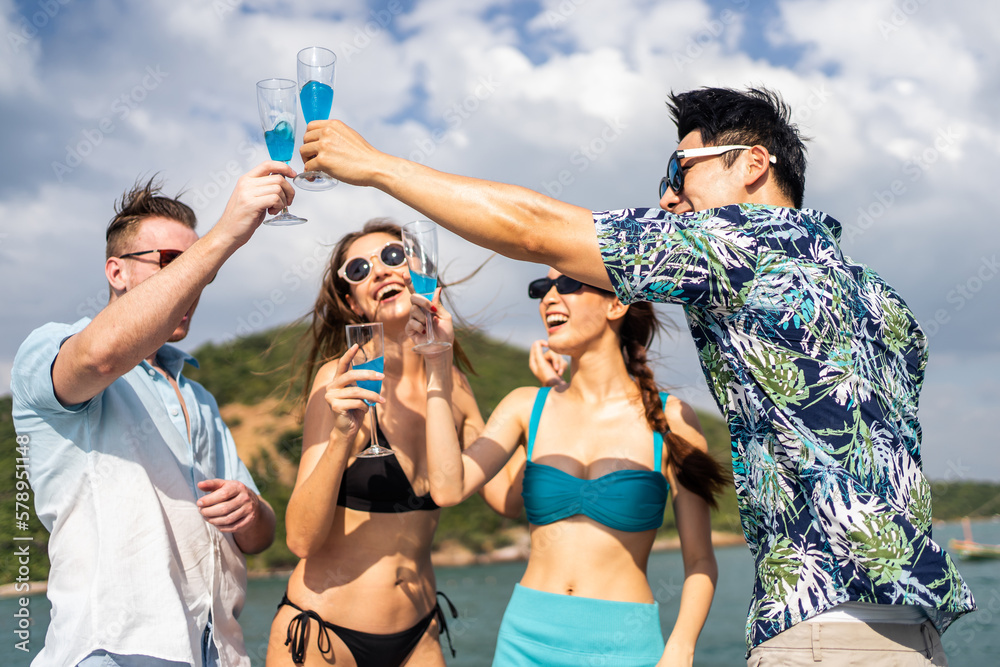 Group of diverse friends drink champagne while having a party in yacht. 