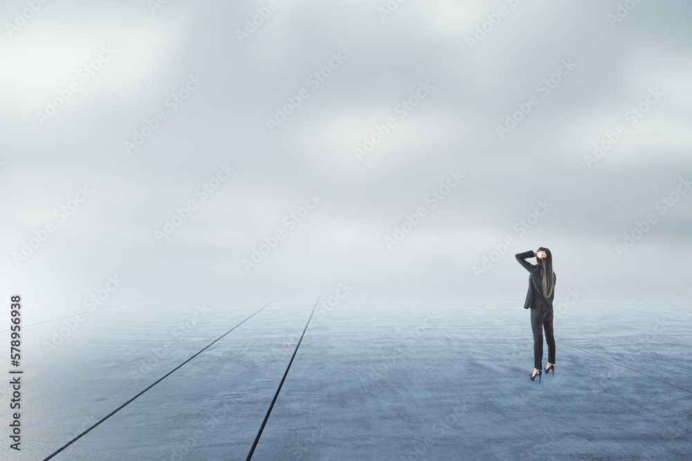 Businesswoman looking into the distance on abstract gloomy sky and ground background with mock up pl