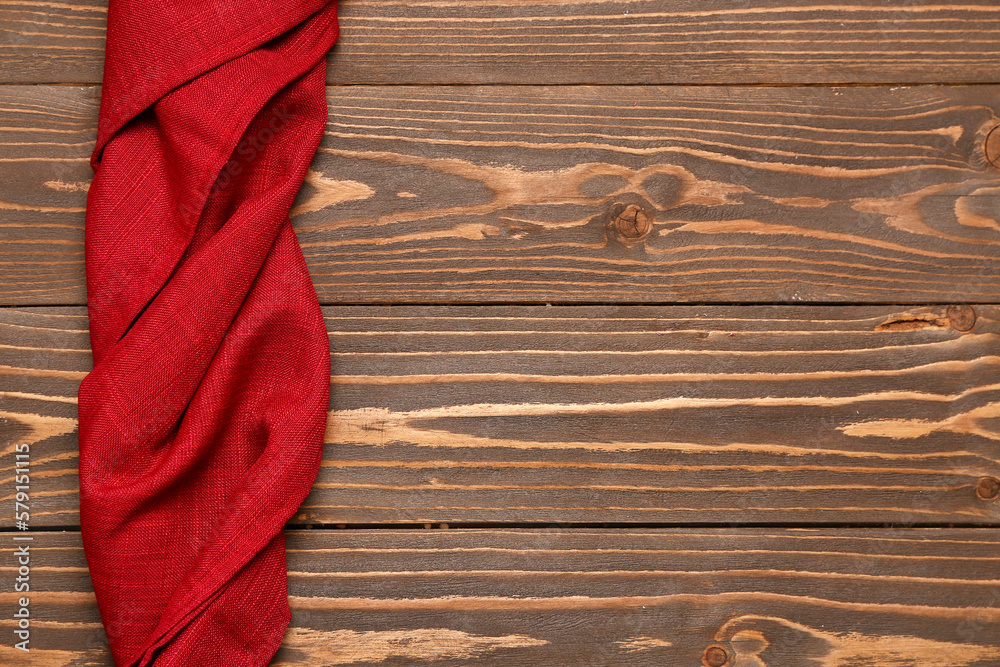 Red twisted napkin on wooden background