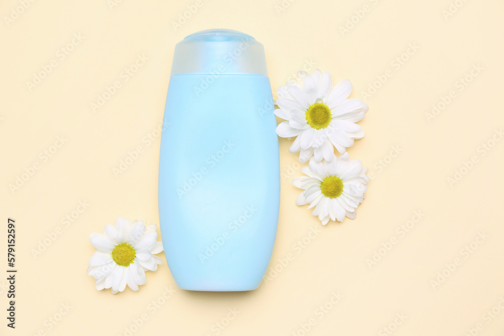 Bottle pf cosmetic product with chamomile flowers on color background