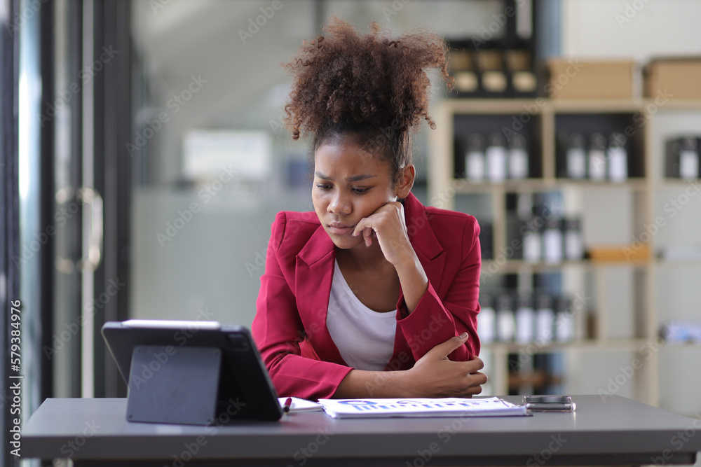 Serious african woman in office stressed and worried about unsuccessfully working on deadlines. Stre