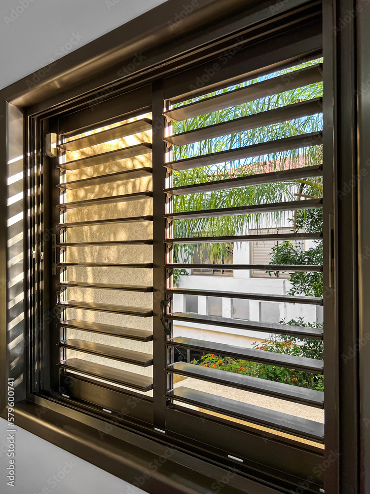 Window with black blinds in room