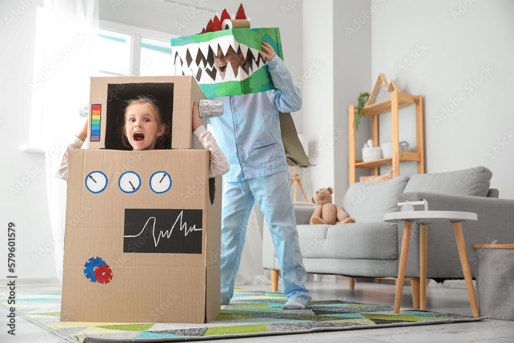 Little children in cardboard costumes playing at home