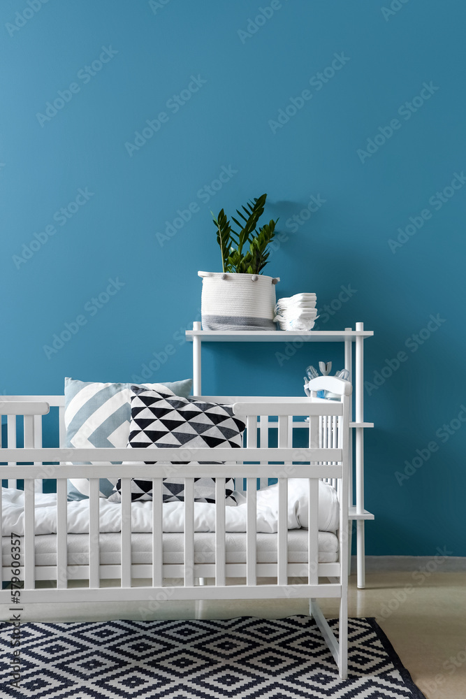 Interior of childrens bedroom with crib and shelving unit