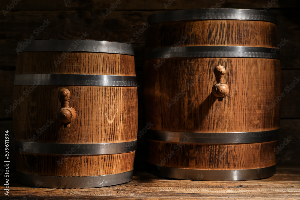 Oak barrels on wooden background