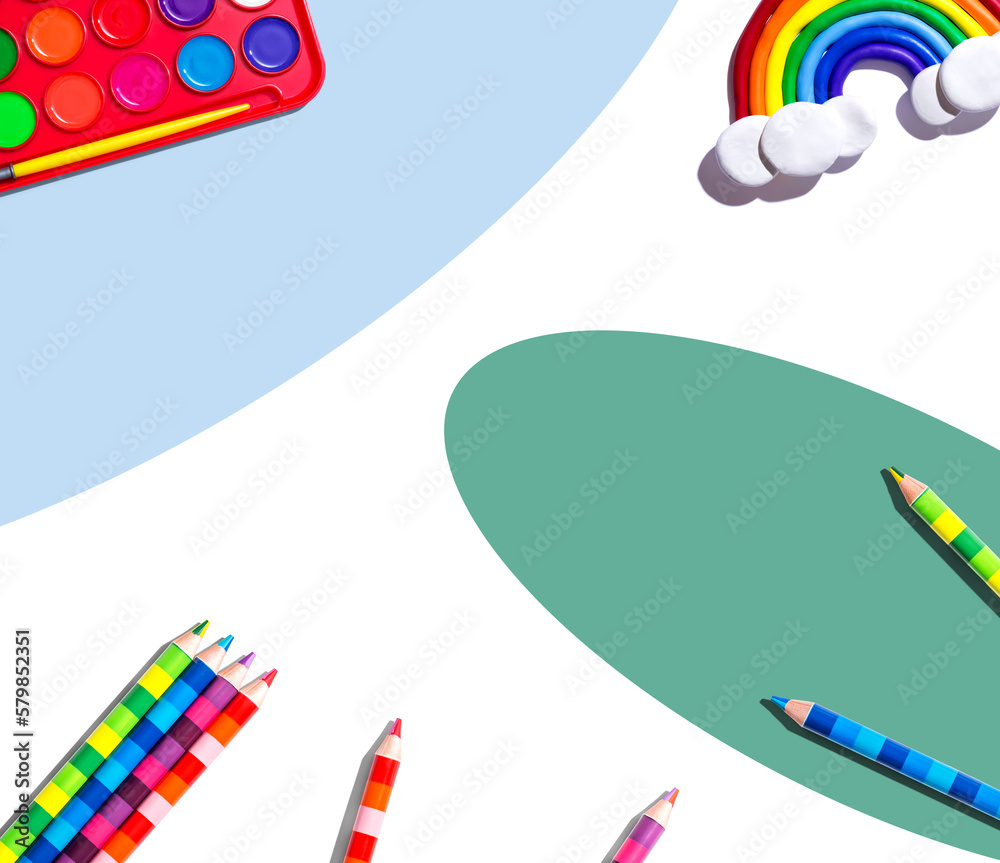 Art supplies with a rainbow - overhead view - flat lay