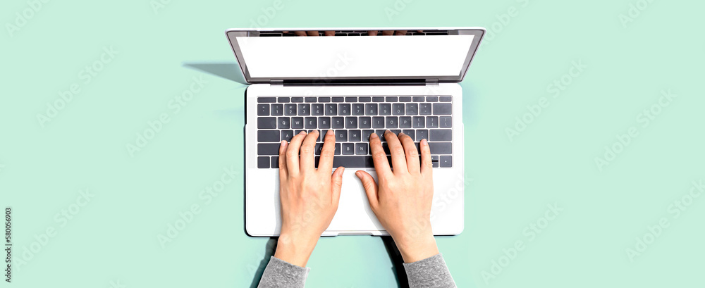 Person using a laptop computer from above