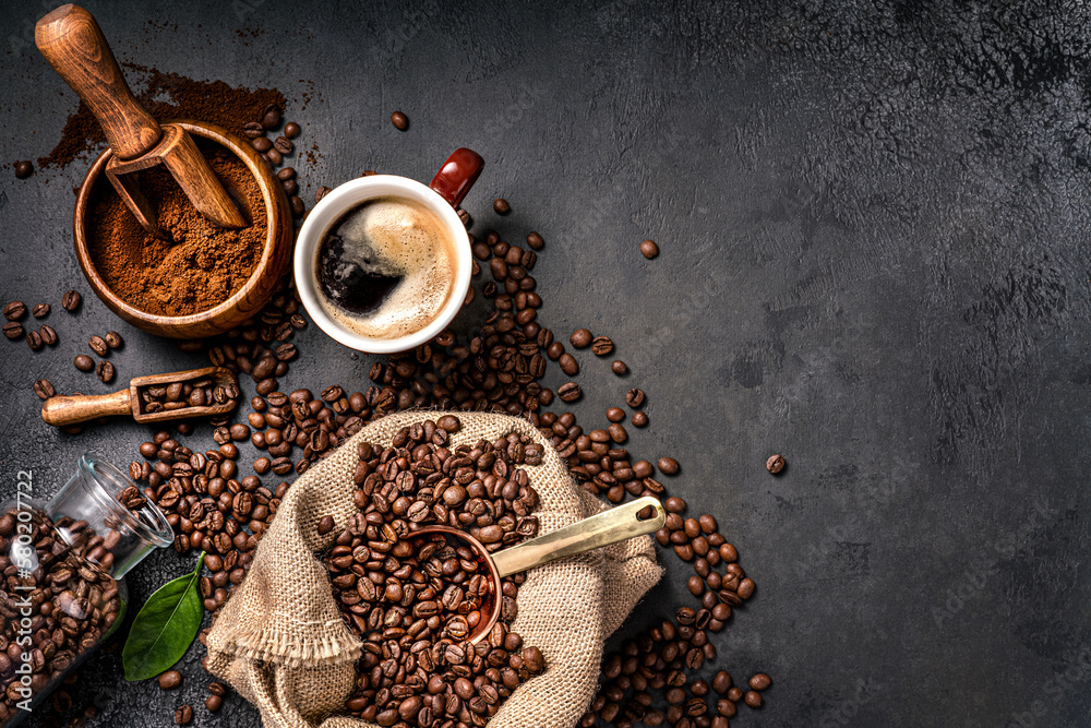 Scoop of coffee beans in a bag on dark background. Top view of coffee in a cup. Copy space for text