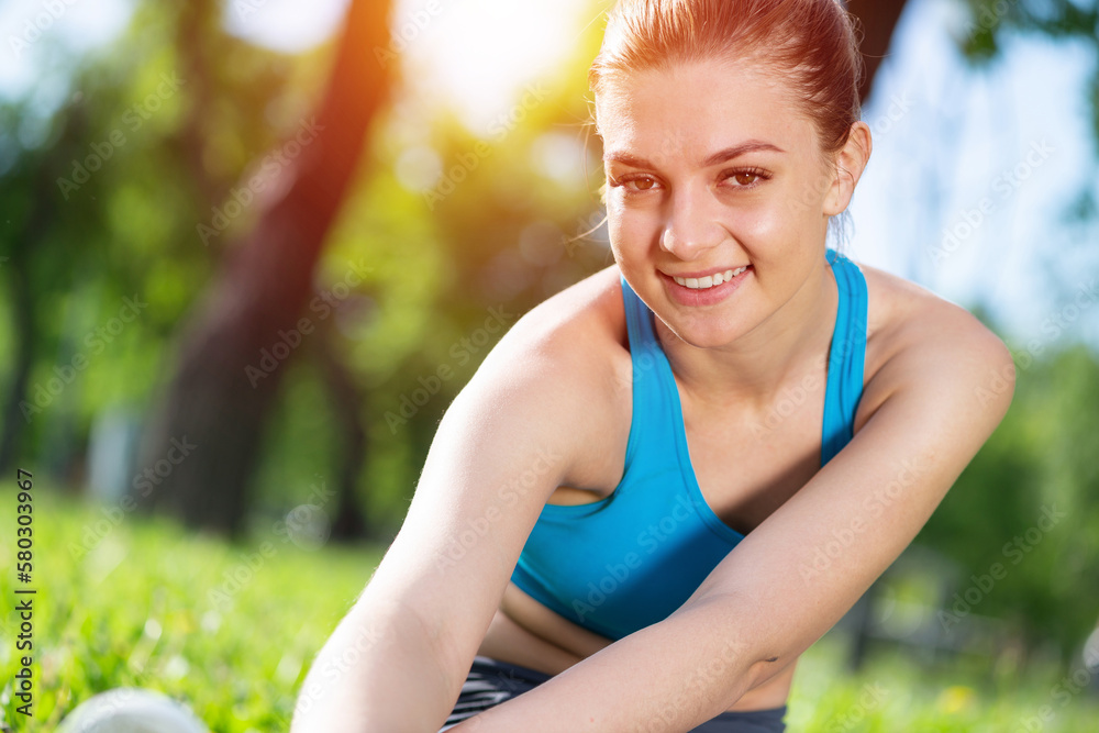 Beautiful smiling girl stretching before fitness