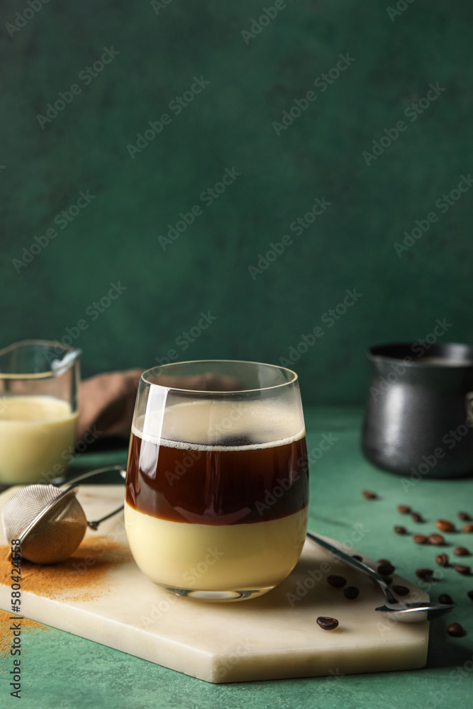 Board with glass of tasty Cafe Bombon on color background