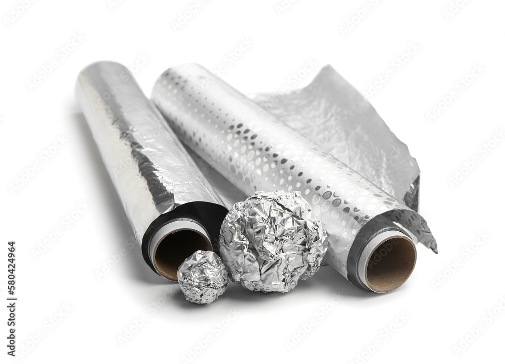 Rolls and balls of aluminium foil on white background