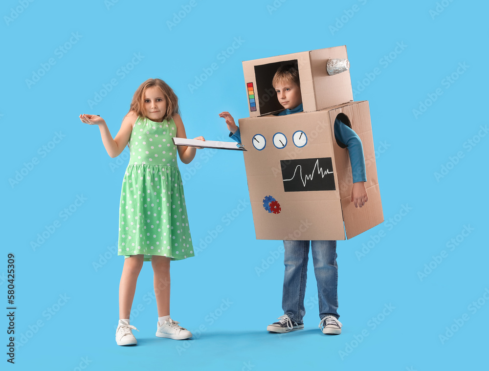 Little girl with clipboard and boy in cardboard robot costume on blue background