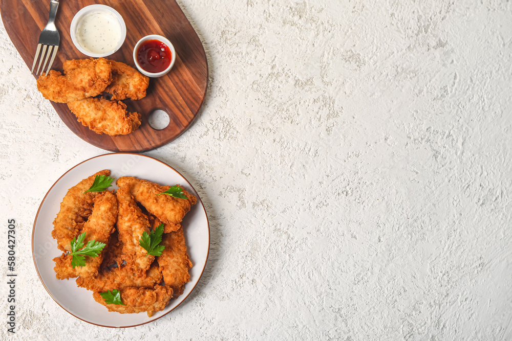 Plate with tasty nuggets and sauces on light background