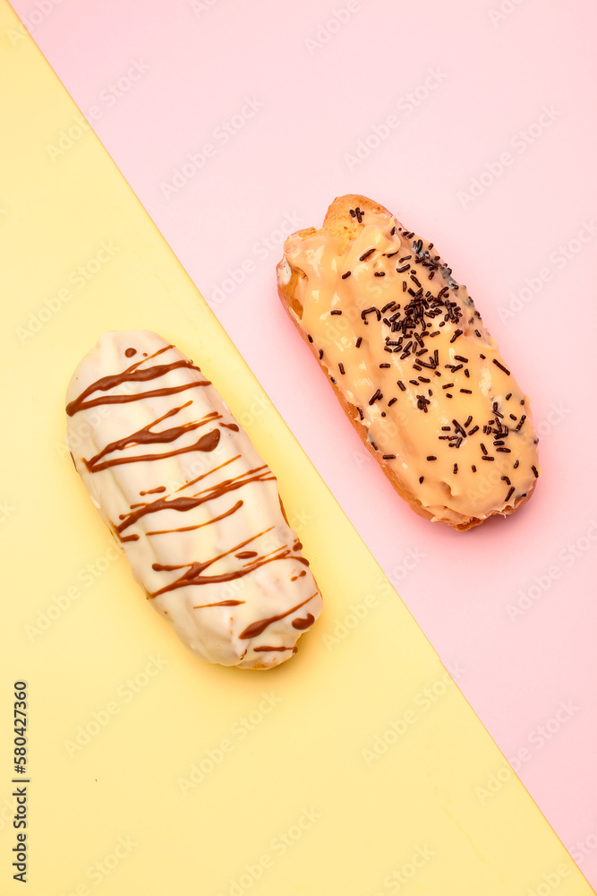 Tasty glazed eclairs on yellow and pink background