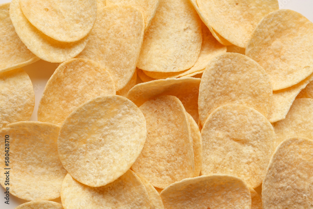 Delicious potato chips as background