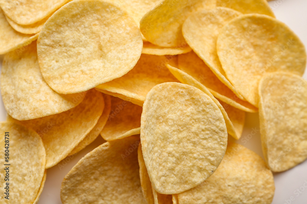 Delicious potato chips on white background, closeup