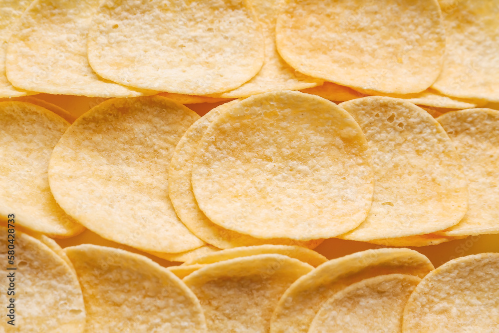 Delicious potato chips as background