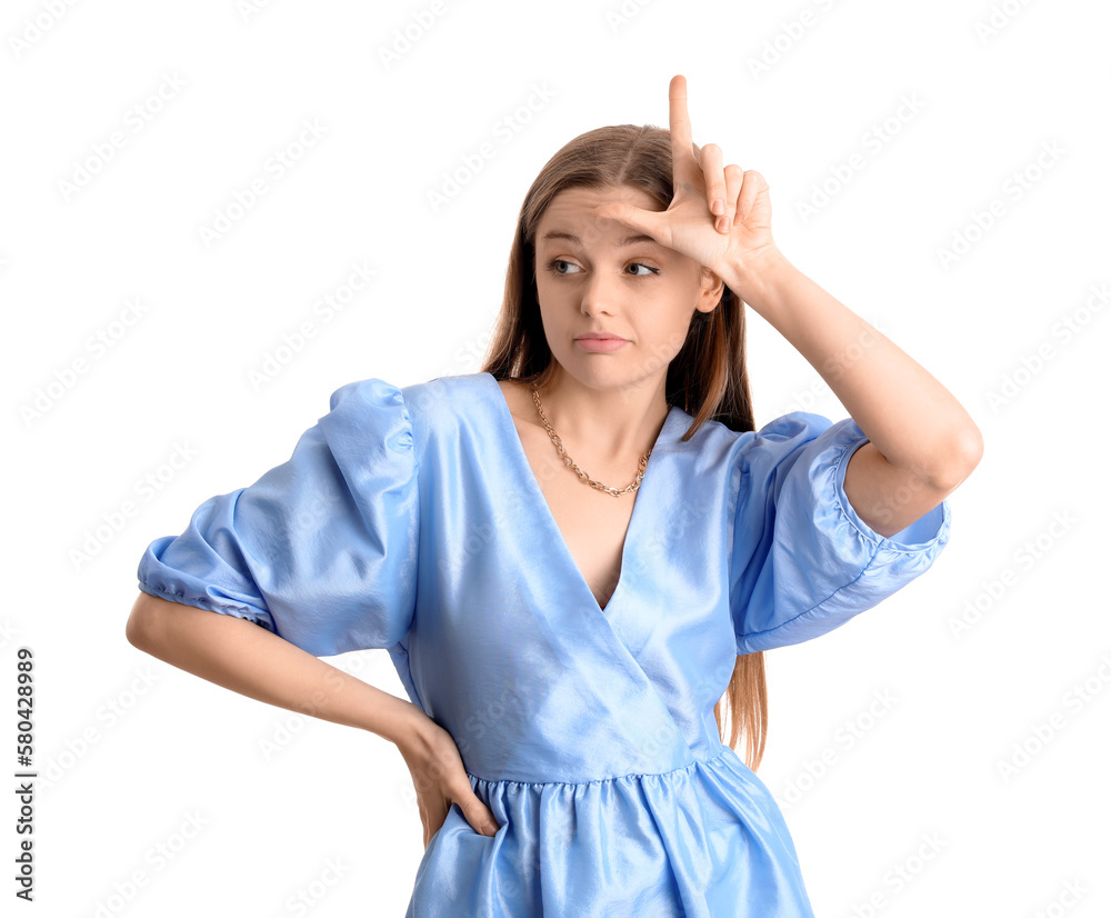 Young woman in dress showing loser gesture on white background