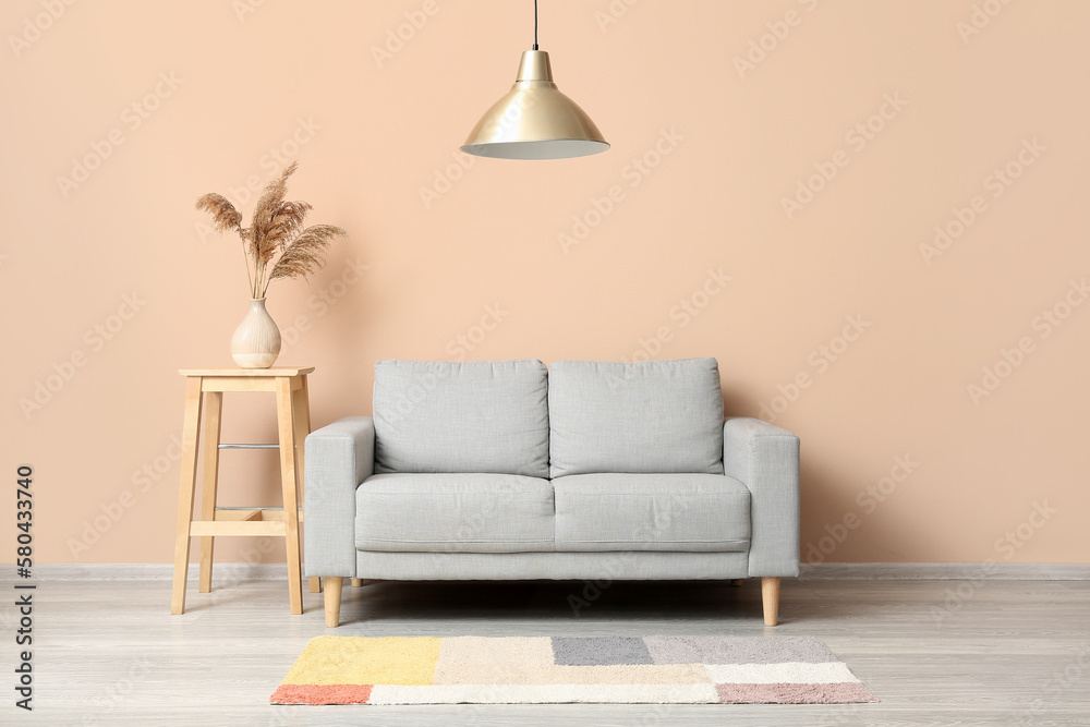 Interior of living room with grey couch and table