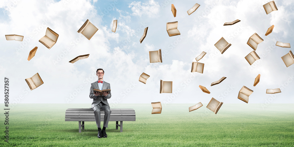 Young businessman or student studying the science and books fly around