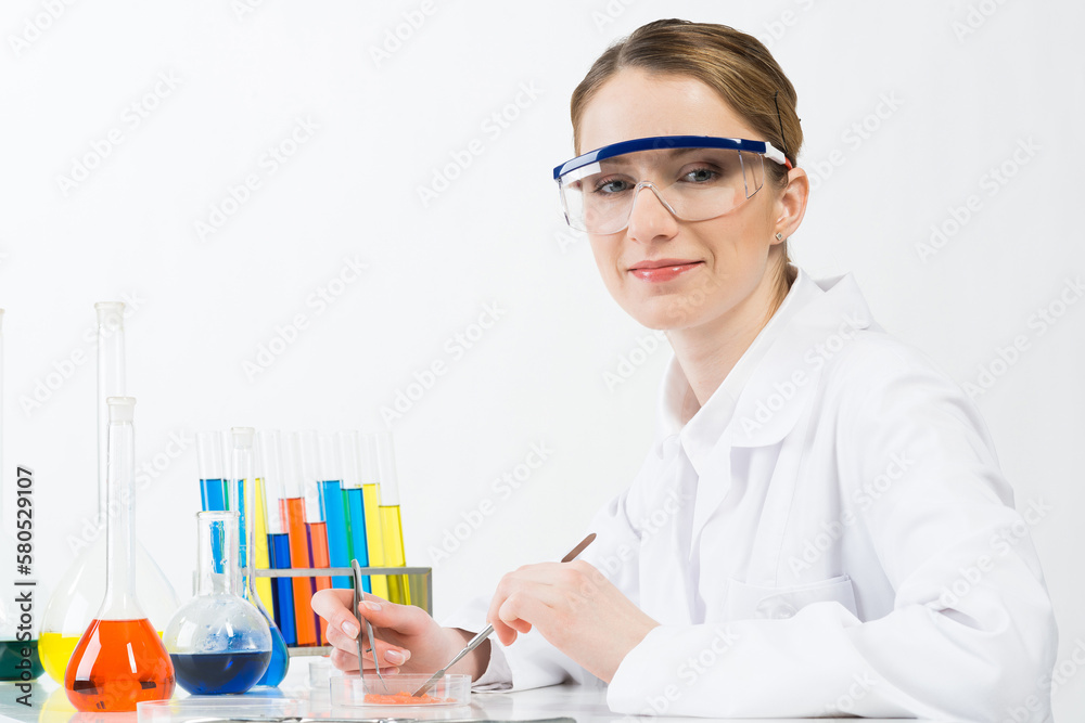 Microbiologist researching sample in petri dish.