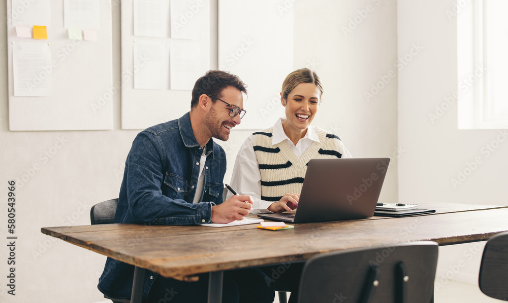 Happy businesspeople having a video conference in a creative office