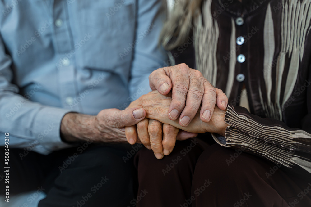 Close up mature spouses holding hands,Support,Couple hands holding in love and comfort together in t