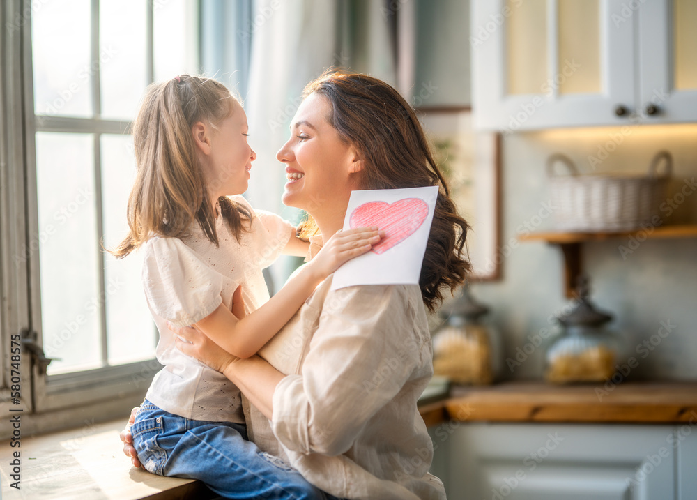 Daughter giving mother bouquet of flowers.