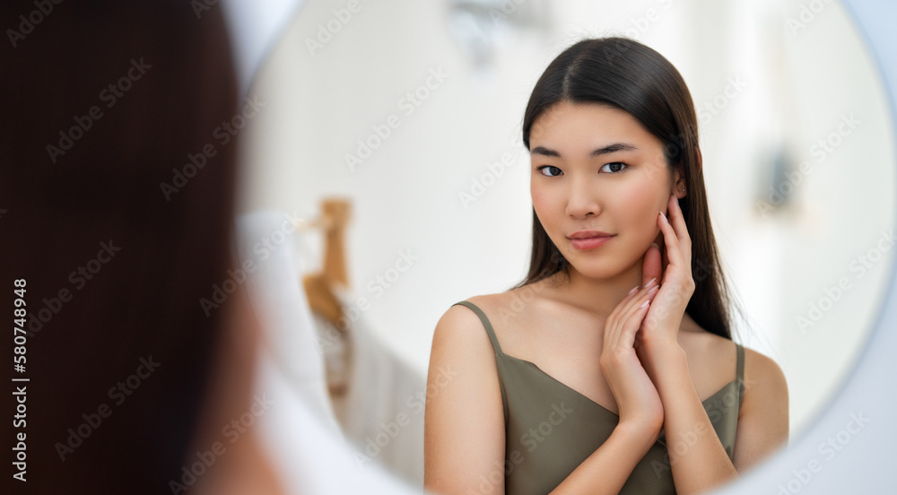 woman looking at mirror