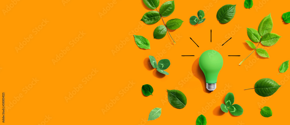 Green light bulb with green leaves - Flat lay