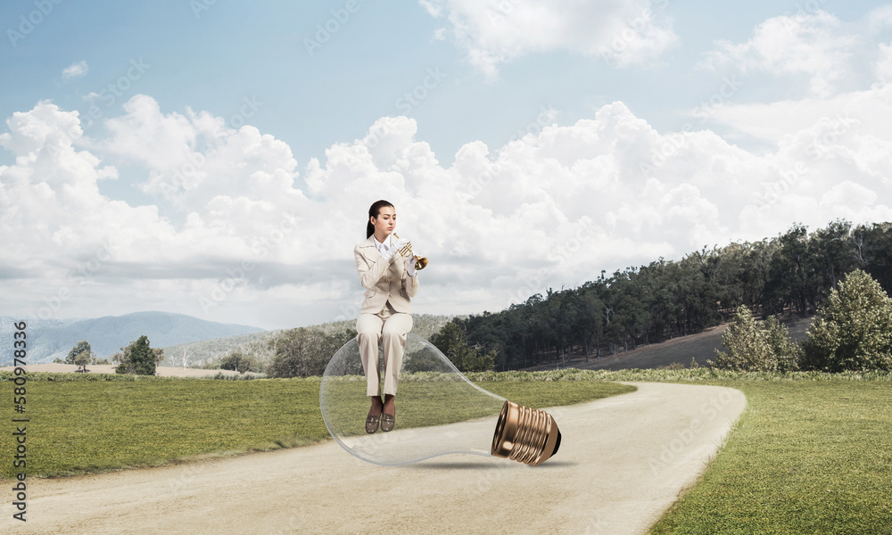 Attractive woman playing trumpet brass