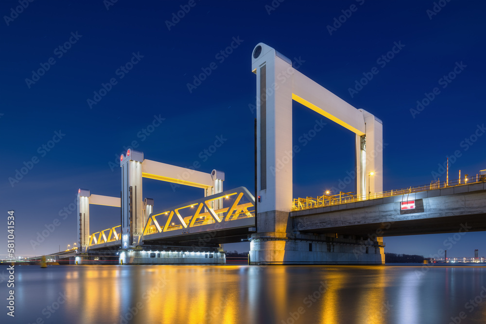 Botlek bridge, Rotterdam, Netherlands. View of the bridge at night.  Road for cars and railroad tran