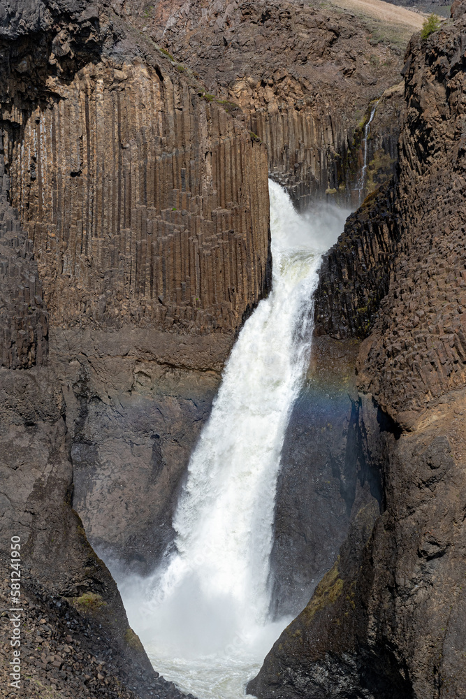 Waterfall Litlanesfoss surrounded by basalt columns in eastern Iceland