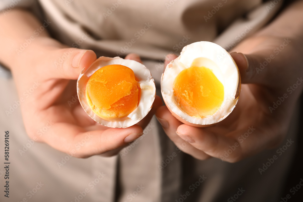 Woman with boiled egg, closeup