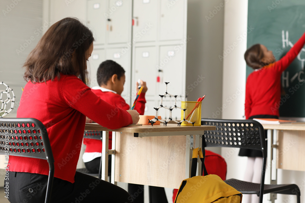 Little children having Chemistry lesson in science classroom