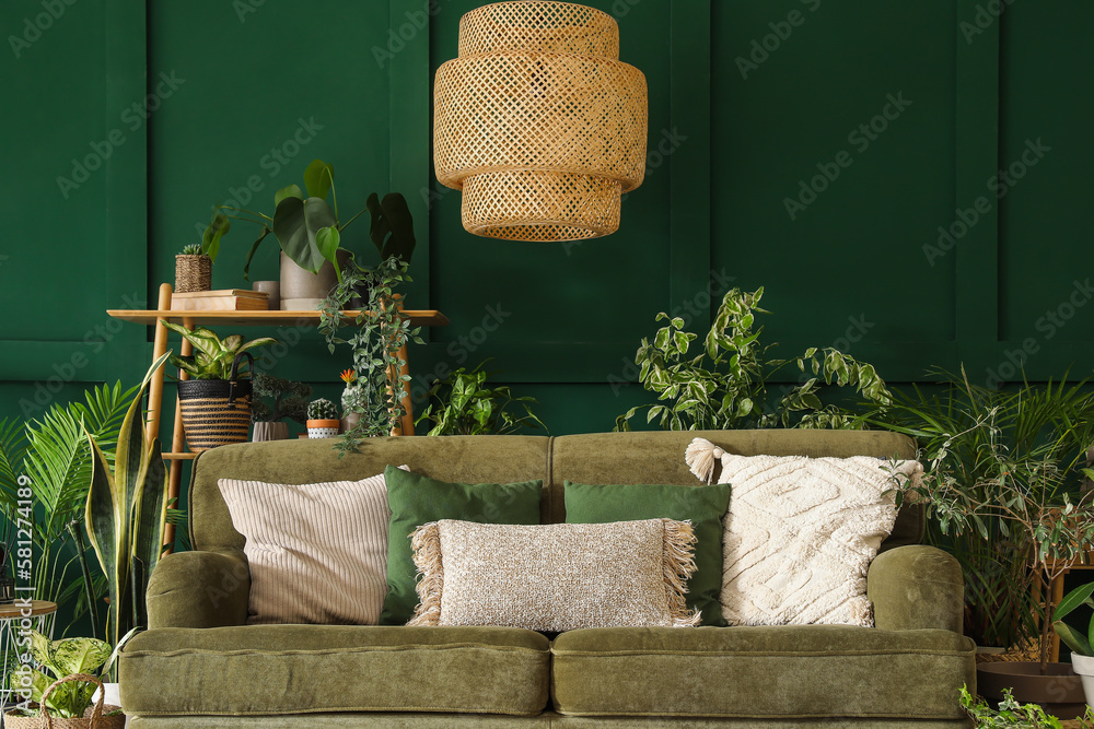 Interior of living room with green sofa and houseplants