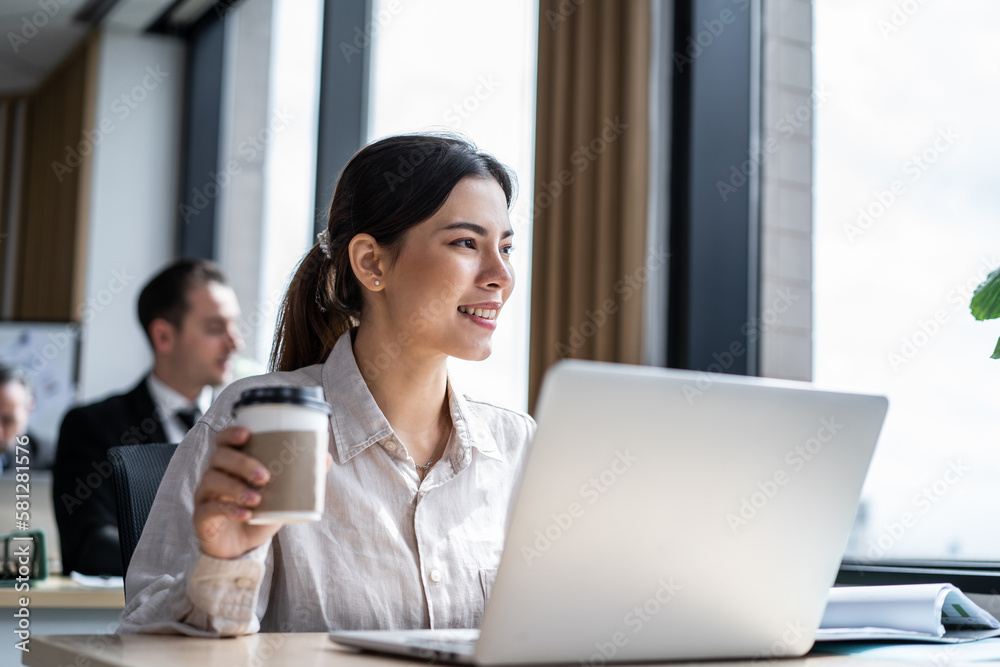 Asian beautiful businesswoman using laptop computer working in office. Attractive young professional