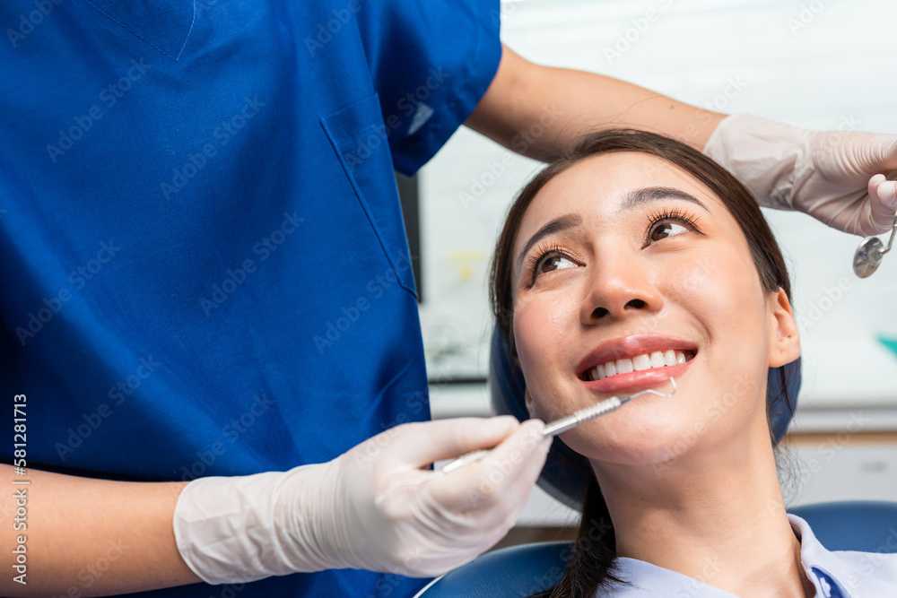 Caucasian dentist examine tooth for young girl at dental health clinic. 