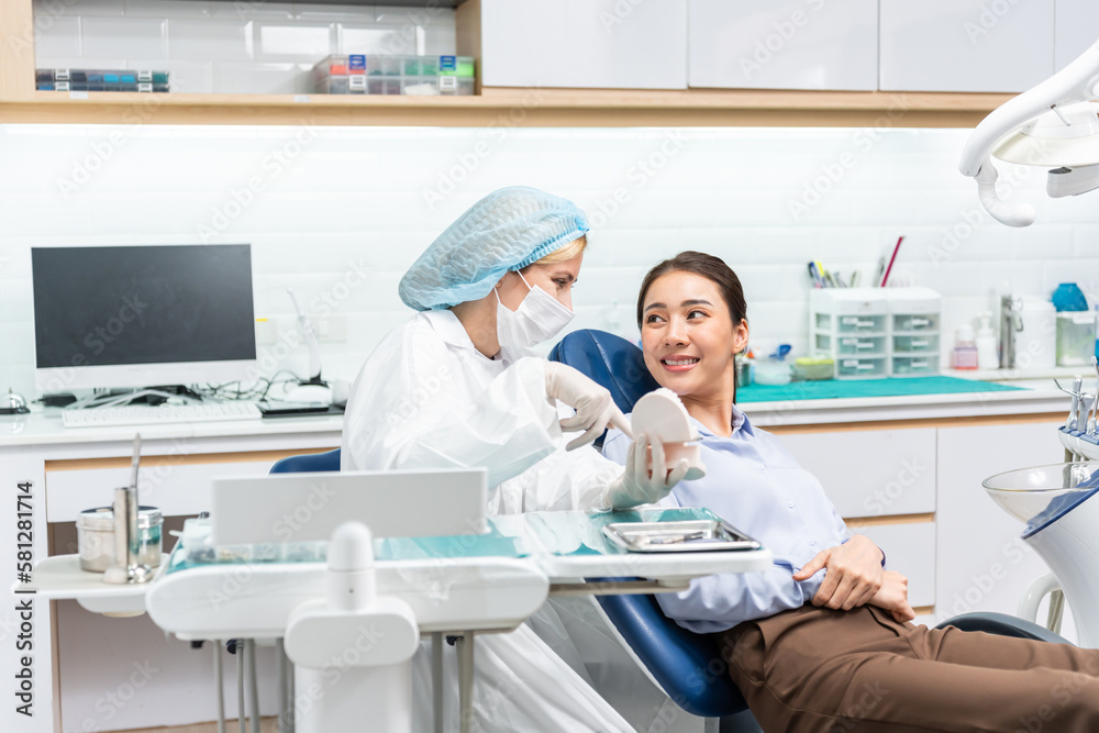 Caucasian dentist examine tooth for young girl at dental health clinic. 