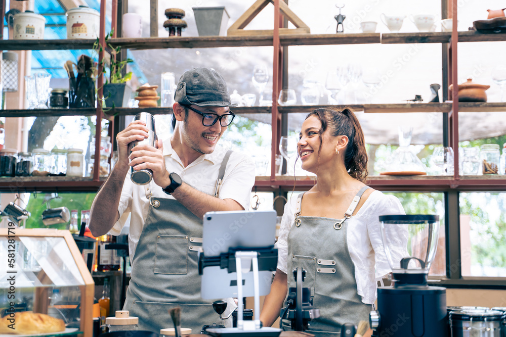 Asian attractive barista and Caucasian waitress working in coffeehouse. 