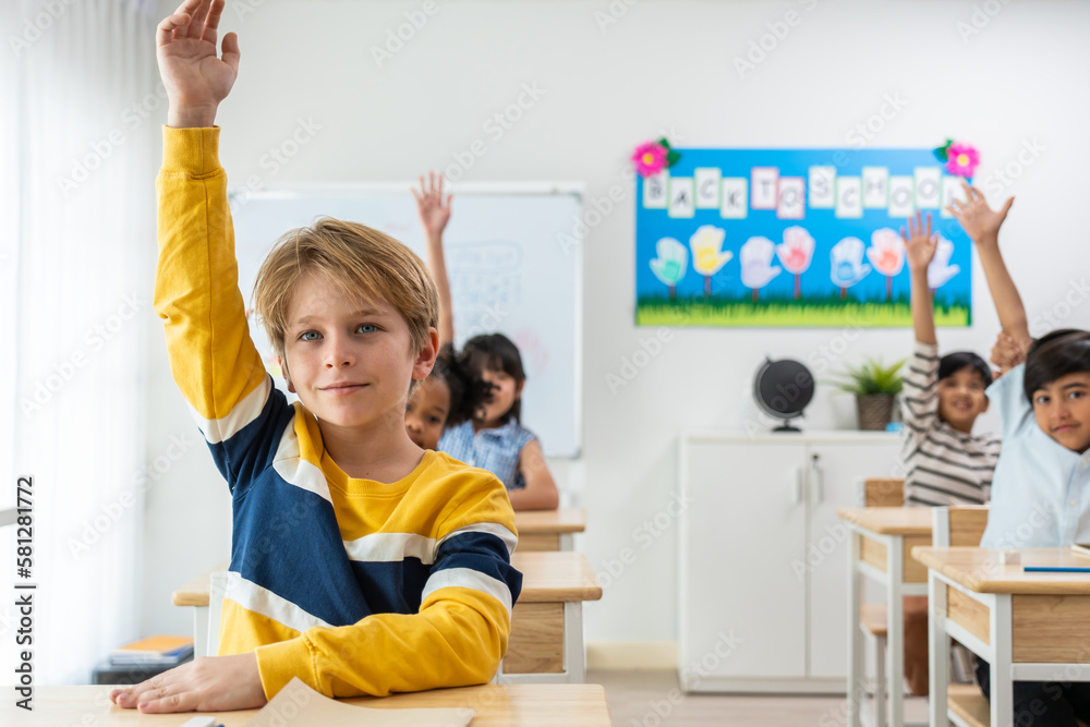 Group of student learn with teacher in classroom at elementary school. 